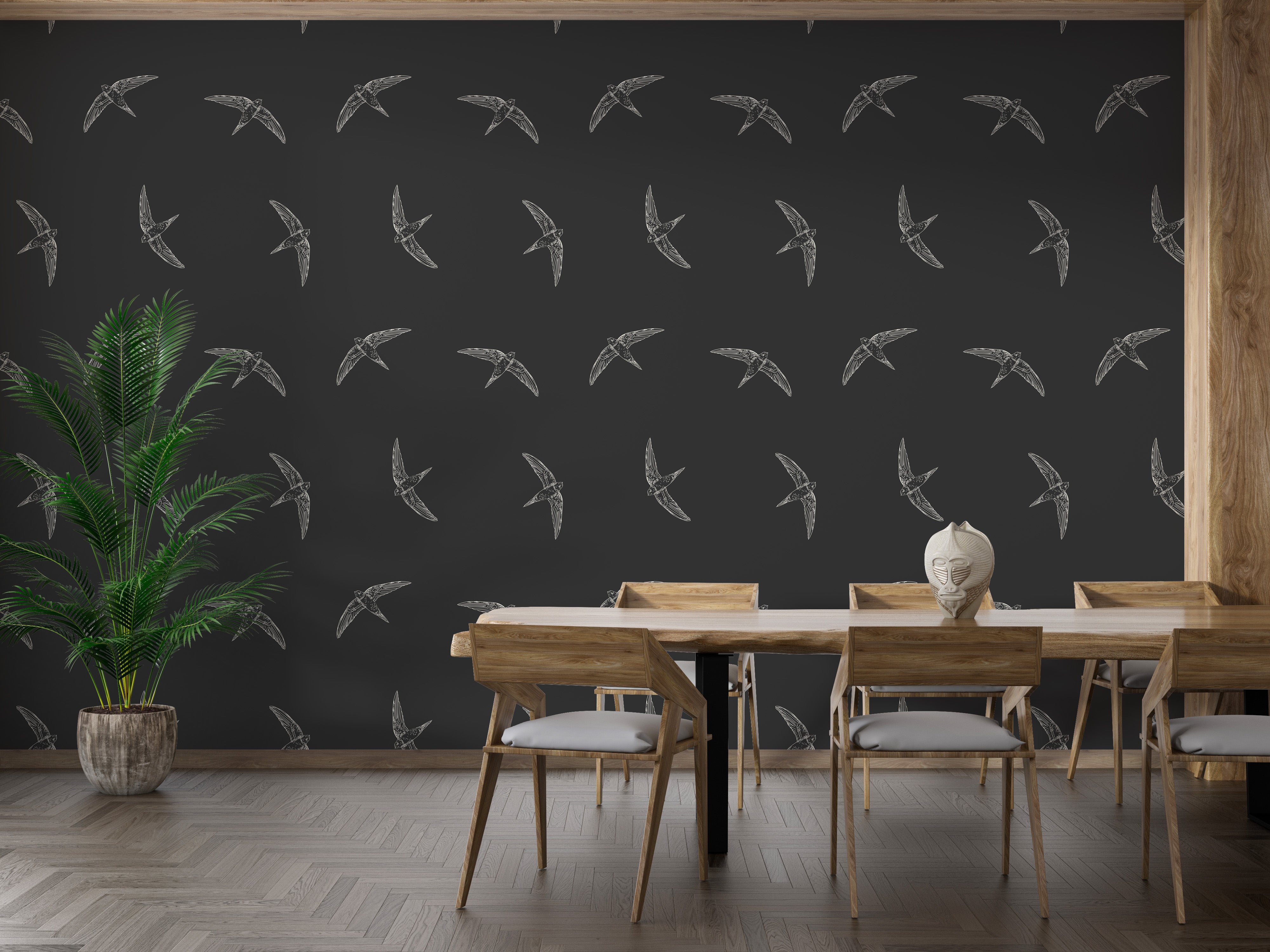 Swallows in flight on striking black wallpaper